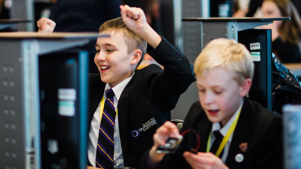 Arm School Program Outwood Academy pupil celebrating fixing a bug